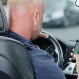 Man uses his phone while driving